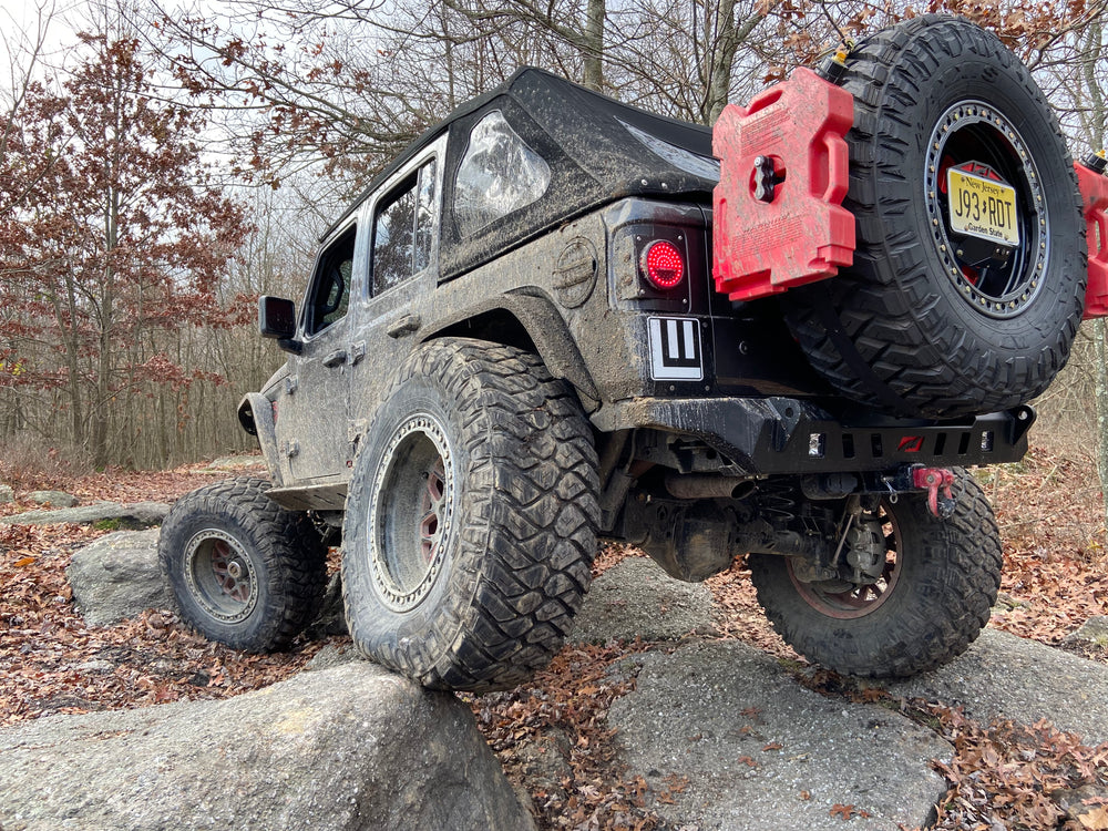 Lifted Jeep Wrangler JL on rocks